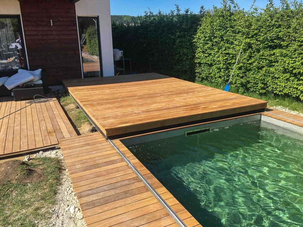 Robuste und stilvolle Poolabdeckung von Terrassen Design Riegler, die Sicherheit und Ästhetik in einem privaten Garten bietet.